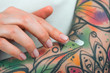 © Artem Markin - Fingers apply cream to skin. Close up
