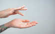 © Artem Markin - Fingers apply cream to skin. Close up