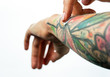 © Artem Markin - Female tattooed hands hold a jar of cream. Fingers apply cream to skin. Close up