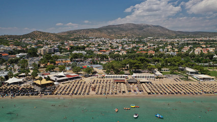 Wall Mural - Aerial drone photo of famous seaside village of Varkiza with deep turquoise sandy beaches and clear blue sky, Athens riviera, Attica, Greece