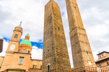 Two medieval towers of Bologna Le Due Torri: Asinelli and Garisenda and Chiesa di San Bartolomeo Gaetano church on Piazza di Porta Ravegnana square in old historical city centre, Emilia-Romagna, Italy