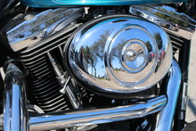 Polished Chrome Elements Of A Motorbike Engine With Reflection, As Closeup