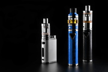 Wall Mural - electronic cigarettes or vaping devices on black background