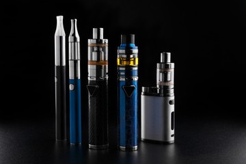 Wall Mural - electronic cigarettes or vaping devices on black background