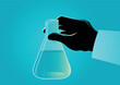 Hand holding a laboratory beaker