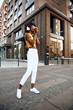 © Yakobchuk Olena - Afro-american woman with coffee walking on the street