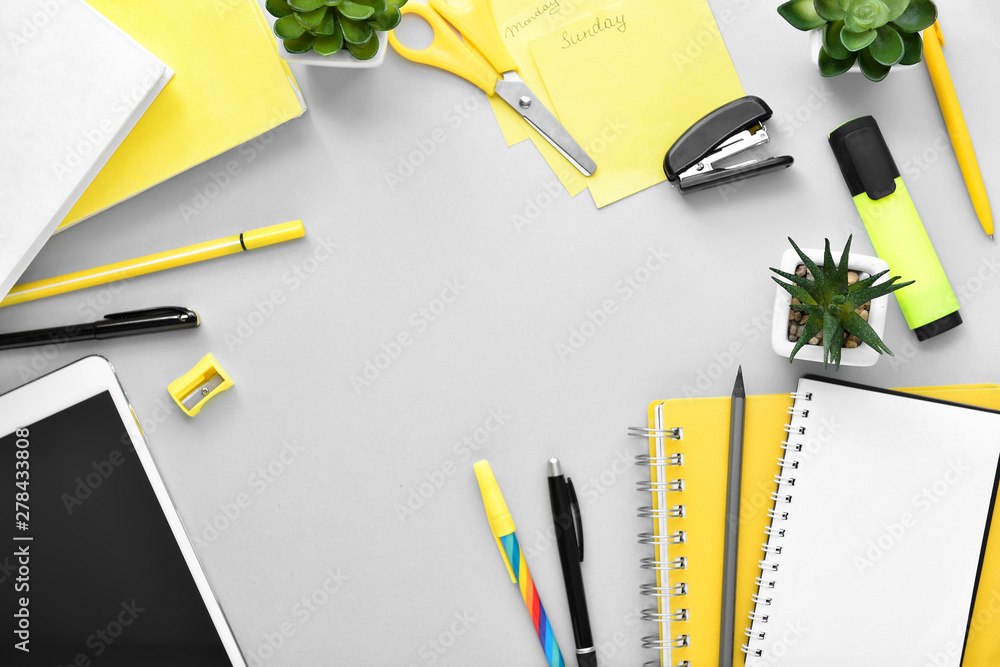 Composition with stationery and tablet computer on grey background