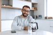 © ASDF - attractive man sitting at the kitchen table in the morning