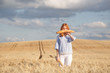 © vladdeep - Funny redhead woman with french baguette in ripe wheat field