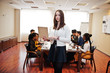 © AS Photo Family - Face of handsome european business woman, holding laptop on the background of business peoples multiracial team meeting, sitting in office table.