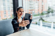 © Тарас Нагирняк - Focus at phone, sportive woman making selfie in cafe, after training.