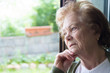 © carballo - older woman looking out the pensive window, seniors