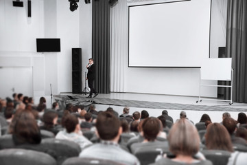audience listens to the speaker in the conference room