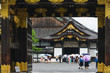 Tourists at the entrance in the Nijo castle in Kyoto in rain with colorful umbrellas during rainy season in Japan