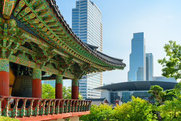 Traditional roof of Buddhist temple and modern buildings