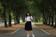© nitimongkolchai - Portrait Of Female Teenage University student uniform between the tree