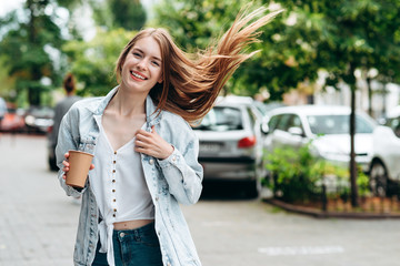 Happy red-hair  woman standing outdoor holding  a coffee glass - Image