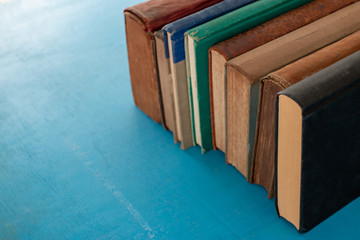 Old books on a blue-green wooden.