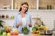 © Prostock-studio - Happy woman cooking dinner, mixing fresh salad in kitchen