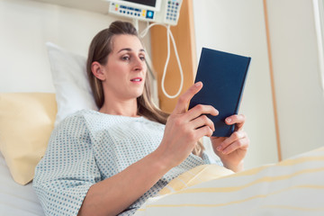 Canvas Print - Woman in hospital bed reading the bible