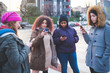 © Eugenio Marongiu - group of young women standing in the street and interacting with smartphone