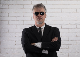 Poster - portrait of an old man, white brick wall background