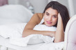 © olenachukhil - Young very attractive woman in bed. Female awake early in the morning. Lady sleeping in the bedroom.