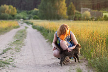 Teenager Girl With Cat On Rural Road