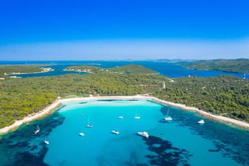 Aerial view of sailing boats in a beautiful azure turquoise lagoon on Sakarun beach on Dugi Otok island, Croatia, beautiful seascape