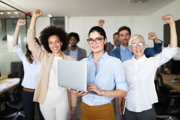 Business team celebrating a good job in the office