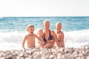 Wall Mural - Happy kids on the beach having fun