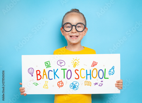 beautiful cute little girl holding a white paper with message Wallpaper Mural