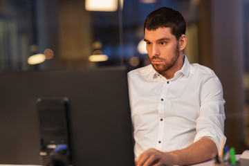 Canvas Print - business, overwork, deadline and people concept - businessman with computer working at night office