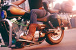 Biker riding on a motorcycle. Bottom view of the legs in leather boots. A man near the office center on a motorcycle in cowboy shoes
