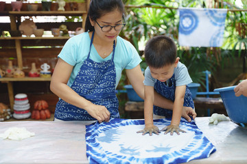 Asian mother and son playing art together