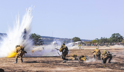 Explosions of bombs and shells. Reconstruction of the battle of world war II. Battle for Sevastopol. Reconstruction of the battle with explosions. Tanks and soldiers during the battle.