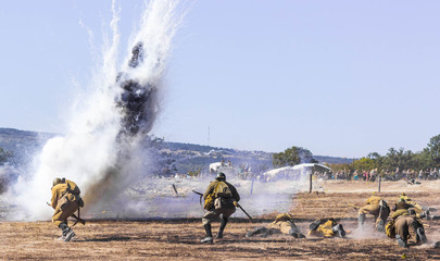 Wall Mural - Explosions of bombs and shells. Reconstruction of the battle of world war II. Battle for Sevastopol. Reconstruction of the battle with explosions. Tanks and soldiers during the battle.