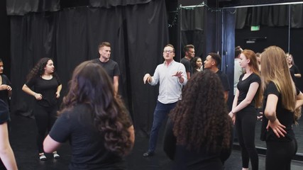 Wall Mural - Teacher With Drama Students At Performing Arts School In Studio Improvisation Class