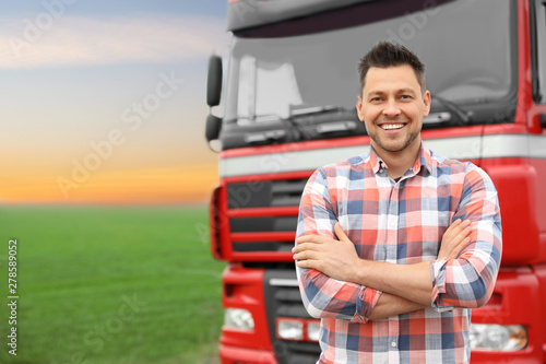 Fotomural Portrait of driver at modern truck outdoors. Space for text