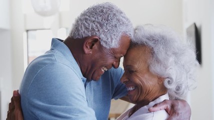 Wall Mural - Profile Shot Loving Senior Couple Hugging At Home Together