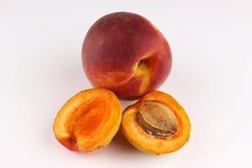 Poster - Peach with a stone on a white background