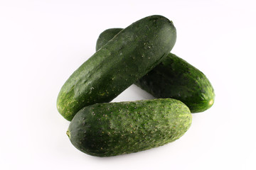 Wall Mural - Green cucumbers on a white background