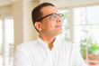 © Krakenimages.com - Middle age man wearing glasses smiling to the camera at home