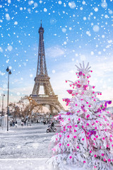 Wall Mural - Eiffel Tower is the main attraction of Paris on the background of  Christmas trees covered by snow in winter. Travel Greeting Card from Paris with love, France