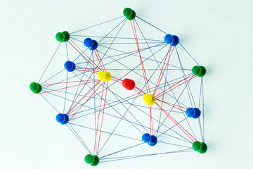 the colored needles are interconnected by a thread, the concept of interaction with each other, and 