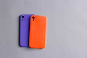 Colorful silicone cases for your smartphone. Bright yellow and purple silicone cases for smartphone. Flat lay.