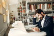 © prostooleh - Man in a library. Guy in a black suit. Student with a books.