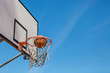 © Westend61 - Basketball and hoop, blue sky
