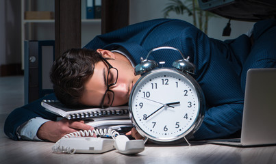 Businessman working overtime long hours late in office