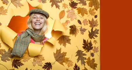 Wall Mural - Beautiful sensual blonde playing with leaves. Girl in autumn in a seasonal clothes whith golden leaf. Happy young woman are preparing for autumn sunny day. Cloud rain umbrella. Raining concept.